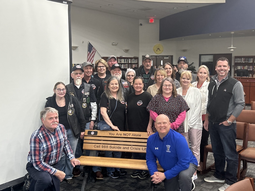 Picture of the Dundee School Board and the Hot Rod Motorcycle members with the bench the group donated.